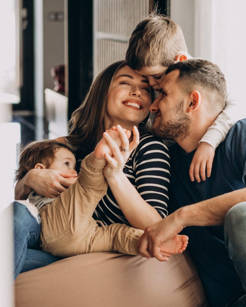 Young family with their sons at home having fun